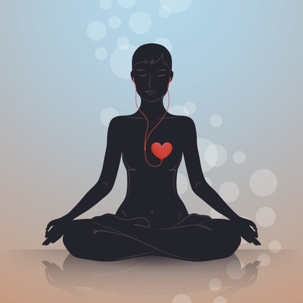 woman sitting in lotus position, listening to headphones connected to heart shape